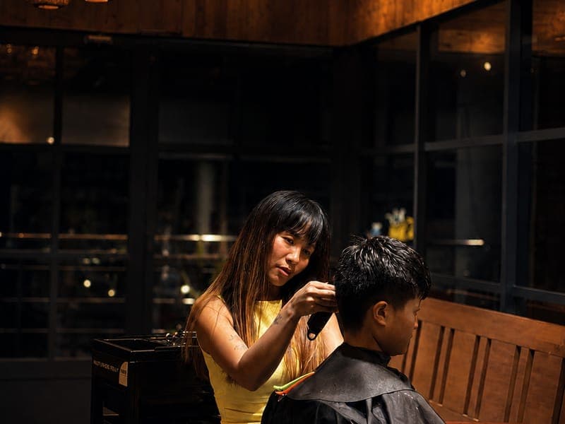 A stylist finishing a men’s haircut at Hair Official