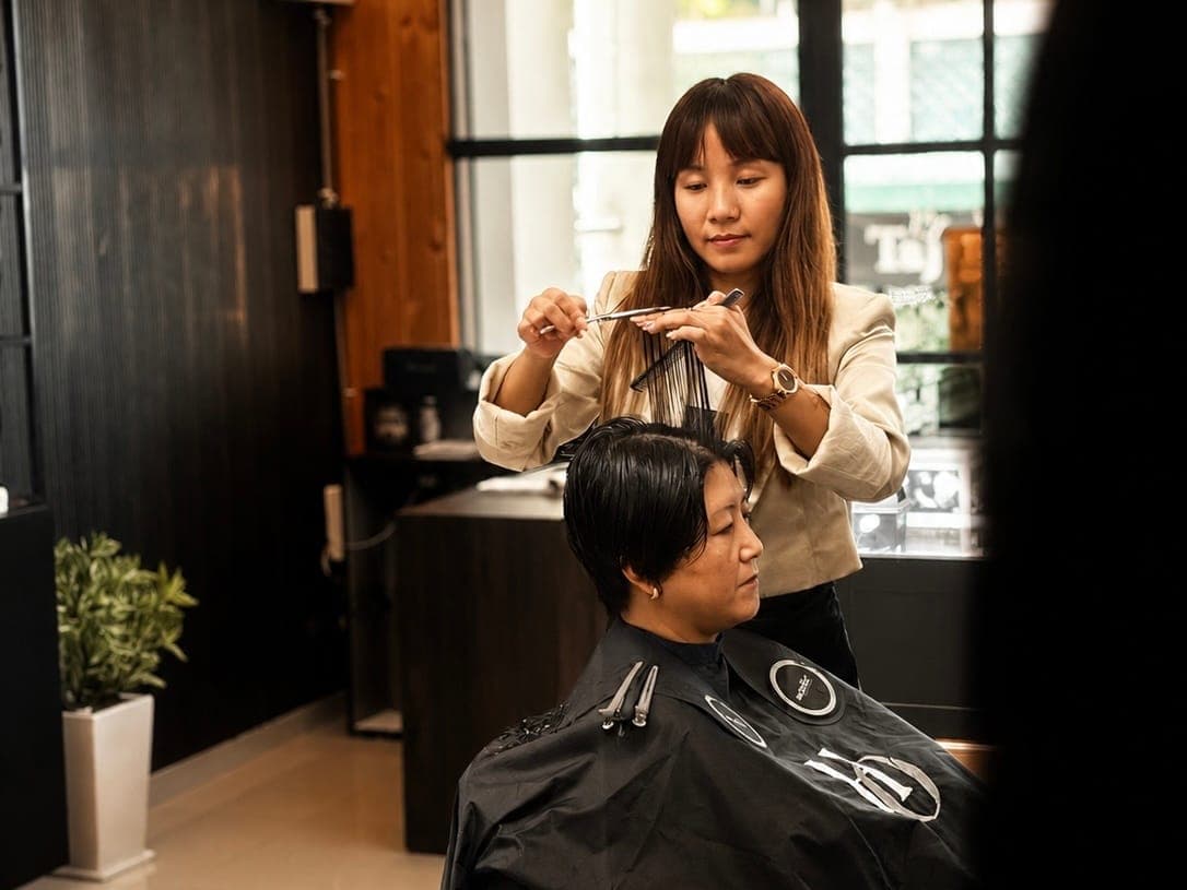 A stylist cutting a client’s hair at Hair Official in Kalimpong